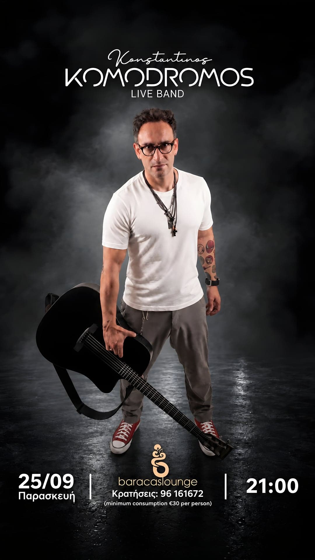 Promotional portrait of Konstantinos Komodromos standing with a black acoustic guitar against smoke-lit black, announced as a live band at Baracas Lounge.